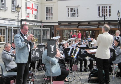 Abbey Brass Band with Trumpet Soloist Standing and English Flag from Saint Georges Day behind